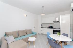 a living room with a couch and a table at Apartments Marina in Postira