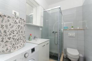 a bathroom with a shower and a toilet and a sink at Apartments Marina in Postira +13 photos