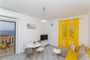 a living room with a couch and a table at Apartments Marina in Postira