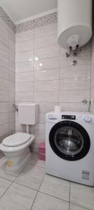 a bathroom with a washing machine and a toilet at Apartment Close to the beach in Stari Grad