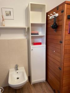 a bathroom with a sink and a white toilet at Little Cottage in Visselhövede +49 photos