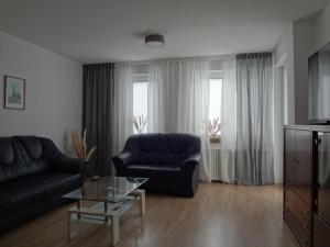 a living room with a couch and a coffee table at Bright Apartment in Boltenhagen near the Sea in Boltenhagen