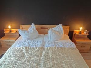 a bedroom with a bed with two lit candles on it at Bright Apartment in Boltenhagen near the Sea in Boltenhagen