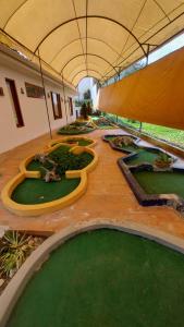 an indoorarium with a bunch of fake golf courses at El Castillo de Nallig in Gualaceo