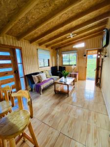 a living room with a couch and a table at Cabaña By Casur panguipulli in Panguipulli