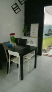 a black table and chairs in a living room at AZhomestay in Jitra