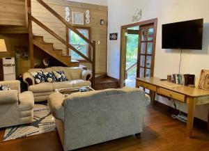 a living room with two couches and a tv at Phoenix House in Sandy Bay