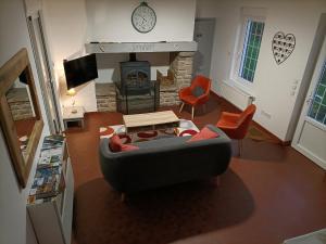 a living room with a couch and a fireplace at Gîte dans le pré Hesdin l'abbé in Carly