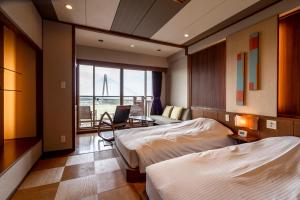 a hotel room with two beds and a desk with a laptop at Tokachigawa Onsen Daiichi Hotel in Otofuke +84 photos
