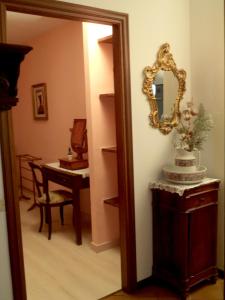 a hallway with a mirror and a table with a cake at B&B Gli Eremiti in Andorno Micca