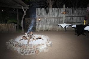 a fire pit in the middle of a yard at night at Masodini Game Lodge in Hoedspruit