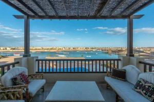 a balcony with couches and a view of the water at El Gouna Lagoon Paradise Penthouse in Hurghada