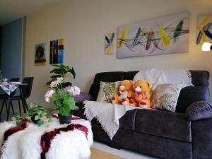 a living room with a couch with stuffed animals on it at Astetica Residences @ Seri Kembangan in Seri Kembangan