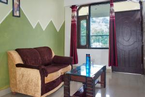 a living room with a couch and a coffee table at Sunrise View Homestay in Kasauli