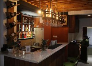a bar with a counter with bottles of wine at The Willows Hotel, Bhutan in Thimphu