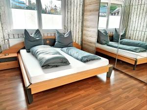 a bedroom with two beds with pillows and a mirror at Fewo Albglück in Albstadt