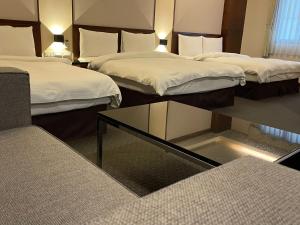 Postel nebo postele na pokoji v ubytování Sun Sweet Hotel