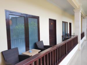 a balcony with chairs and a table on it at Radha Bali Hotel in Kuta