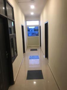 a hallway with a view of a room with a window at Hotel Shree Shyam By WB Inn in Gurgaon