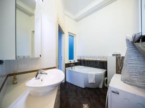 a bathroom with a sink and a bath tub at Captain Buda Apartment in Budapest