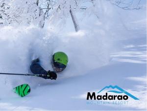a person on skis in the snow at Madarao Kogen Hotel in Iiyama