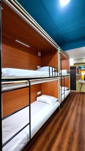 a room with three bunk beds on a boat at Rahul Men's AC Dormitory in Navi Mumbai