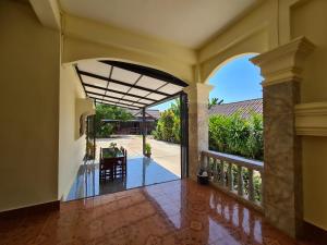 an open hallway of a house with a balcony at Saphaothong guesthouse in Vang Vieng