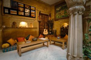 a living room with two couches and a guitar at Moustache Jaisalmer in Jaisalmer