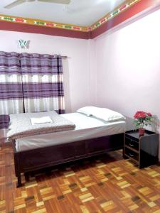 sypialnia z łóżkiem i oknem w obiekcie Hotel Sauraha Gaida House w mieście Chitwan
