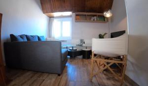 a living room with a couch and a table at Duplex Holidays Andorra in Pas de la Casa