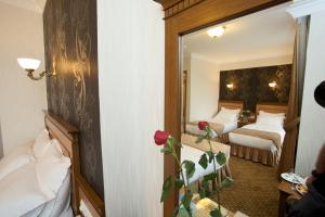 Un ou plusieurs lits dans un hébergement de l'établissement Grand Unal Hotel