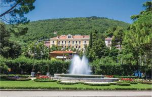 a fountain in a park in front of a building at Awesome Apartment In Icici With House Sea View in Ičići