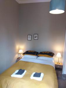 a bedroom with a bed with two towels on it at The City Braveheart in Edinburgh