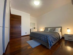 a bedroom with a bed and a wooden floor at Gulliver in Latina