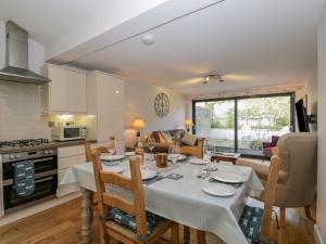 a kitchen and living room with a table and chairs at 1 Countess Chapel in Bath