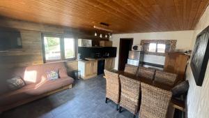 a living room with a couch and a table with chairs at APPARTEMENT COSY AUX SAISIES n1 in Les Saisies