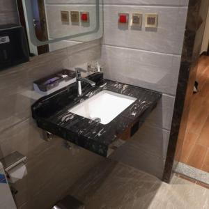 a bathroom sink with a black counter top at لابرادوريت in Jeddah