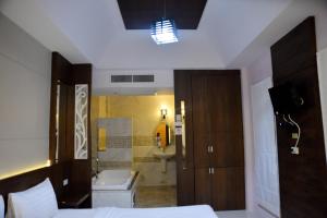 a bedroom with a bathroom with a toilet and a sink at Chanpraya Resort in Chanthaburi