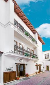 a white apartment building with a balcony at Rodina Suites Hotel in Kusadası