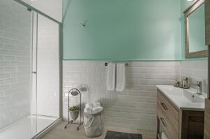 a bathroom with a glass shower and a sink at Rodina Suites Hotel in Kusadası +46 photos