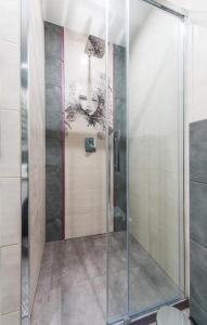 a shower with a glass door in a bathroom at Cztery Oceany 209 in Gdańsk