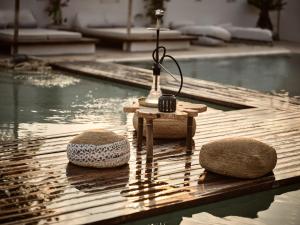 a lamp sitting on a table next to a swimming pool at GARDELLI RESORT in Laganas