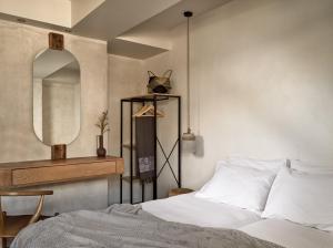a bedroom with a bed and a mirror at GARDELLI RESORT in Laganas
