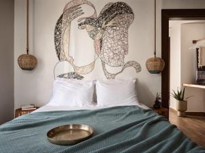a bed with a metal bowl on top of it at GARDELLI RESORT in Laganas
