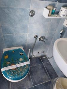 a bathroom with a toilet with a fish bowl on the seat at Hotel Sirenetta in Anzio
