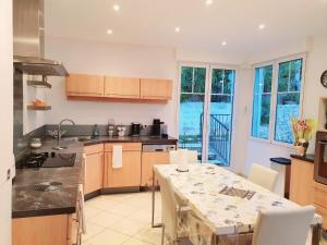a kitchen with a table and a table and a table and chairs at Villa Moana in Èze