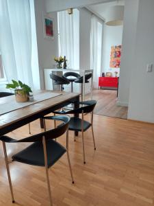 ein Esszimmer mit einem Holztisch und schwarzen Stühlen in der Unterkunft Vienna Charm Apartment in Wien