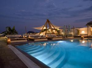 a swimming pool with lounge chairs and a tent at GARDELLI RESORT in Laganas