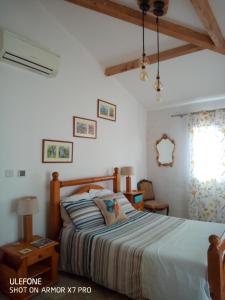 a bedroom with a bed and a window at Olive View in Puissalicon