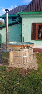 a hot tub in front of a house at Penzion Severka in Rokytnice v Orlických Horách